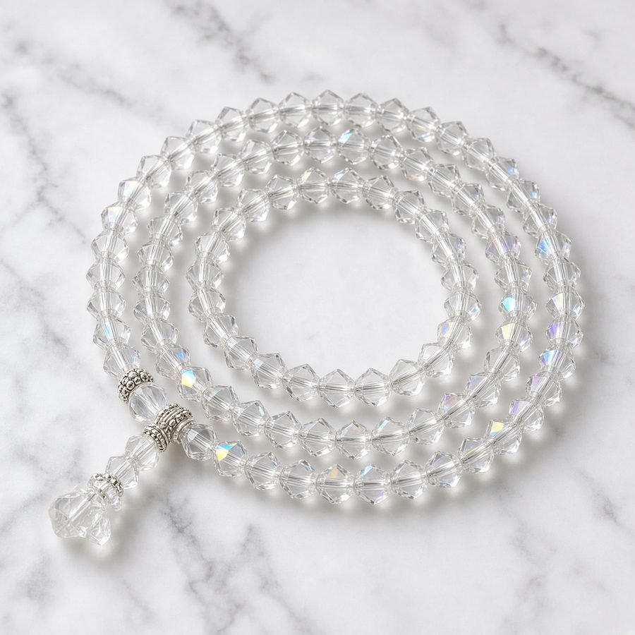 Clear crystal sphatik mala on white marble